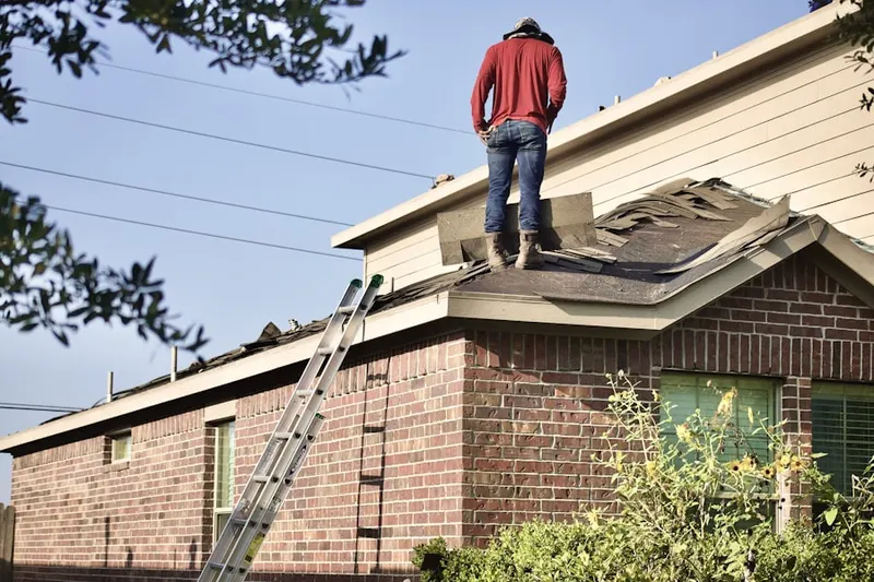 Professional roofer working on a residential roof in Meadowcreek Estates